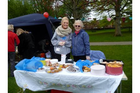 Volunteers selling cakes to raise money