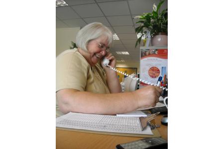Jenny, an Information Line Volunteer helps clients